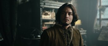 Movie still from “Anonymous” (2011), directed by Roland Emmerich – A man with long brown hair wearing a brown jacket; Close Up shot, Over the shoulder angle