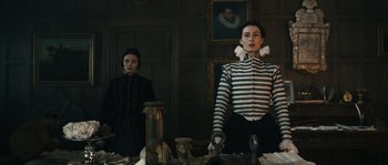 Movie still from “Anonymous” (2011), directed by Roland Emmerich – Two women standing next to each other in front of a mirror; Medium shot, Low angle