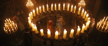 Movie still from “Anonymous” (2011), directed by Roland Emmerich – A nativity scene with candles in the center of it; Extreme Wide shot, High angle