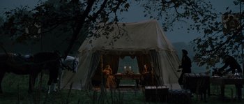 Movie still from “Anonymous” (2011), directed by Roland Emmerich – Two people sitting at a table in front of lit candles; Extreme Wide shot, High angle