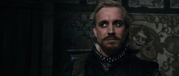 Movie still from “Anonymous” (2011), directed by Roland Emmerich – A person with a beard and mustache; Close Up shot, Over the shoulder angle