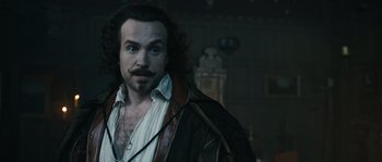 Movie still from “Anonymous” (2011), directed by Roland Emmerich – A man with long hair and a beard; Close Up shot, Over the shoulder angle