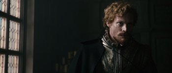 Movie still from “Anonymous” (2011), directed by Roland Emmerich – A person wearing a suit of armor; Close Up shot, Over the shoulder angle