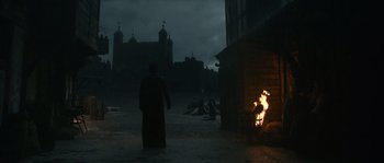 Movie still from “Anonymous” (2011), directed by Roland Emmerich – A man standing in front of a fire pit; Extreme Wide shot, Low angle