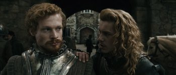 Movie still from “Anonymous” (2011), directed by Roland Emmerich – Two men in medieval garb standing next to each other; Close Up shot, Over the shoulder angle
