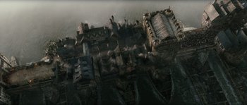 Movie still from “Anonymous” (2011), directed by Roland Emmerich – An aerial view of an old building in the middle of the night; Extreme Wide shot, High angle