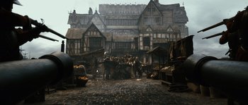 Movie still from “Anonymous” (2011), directed by Roland Emmerich – A group of people standing in front of a building; Extreme Wide shot, High angle