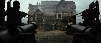 Movie still from “Anonymous” (2011), directed by Roland Emmerich – A group of people standing in front of a building; Wide shot, High angle