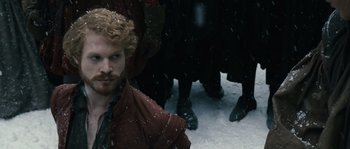 Movie still from “Anonymous” (2011), directed by Roland Emmerich – A man with a beard is standing in the snow; Close Up shot, Over the shoulder angle
