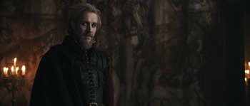 Movie still from “Anonymous” (2011), directed by Roland Emmerich – A man with long hair and a beard standing in front of a painting; Medium shot, Over the shoulder angle