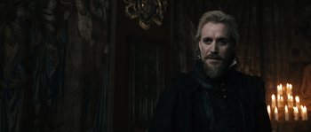 Movie still from “Anonymous” (2011), directed by Roland Emmerich – A person wearing a black jacket; Medium shot, Over the shoulder angle