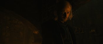 Movie still from “Anonymous” (2011), directed by Roland Emmerich – A man with long blonde hair standing in the dark; Close Up shot, Over the shoulder angle