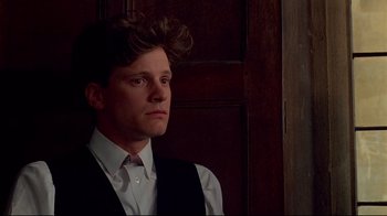 Movie still from “Another Country” (1984), directed by Marek Kanievska – A man in a vest and tie looking to his left; Close Up shot, Low angle