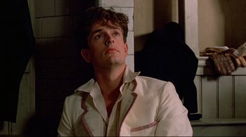 Movie still from “Another Country” (1984), directed by Marek Kanievska – A man in a white shirt is looking up; Close Up shot, Low angle