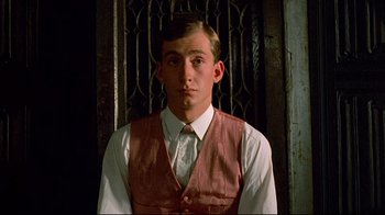 Movie still from “Another Country” (1984), directed by Marek Kanievska – A man in a vest and a white dress shirt; Close Up shot, Low angle