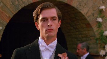 Movie still from “Another Country” (1984), directed by Marek Kanievska – A young man in a suit and bow tie; Close Up shot, Over the shoulder angle