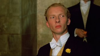 Movie still from “Another Country” (1984), directed by Marek Kanievska – A man in a tuxedo with a yellow rose; Close Up shot, Low angle
