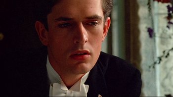 Movie still from “Another Country” (1984), directed by Marek Kanievska – A person wearing a suit and bow tie; Close Up shot, Low angle