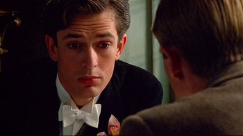 Movie still from “Another Country” (1984), directed by Marek Kanievska – A man in a suit and bow tie looking at another man in a suit and bow tie; Close Up shot, Over the shoulder angle