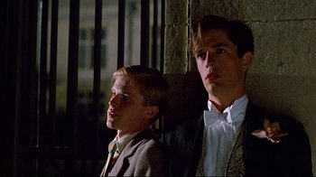 Movie still from “Another Country” (1984), directed by Marek Kanievska – Two young men standing next to each other in front of a brick wall; Close Up shot, Low angle
