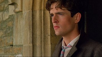 Movie still from “Another Country” (1984), directed by Marek Kanievska – A man in a suit and tie looking to his left; Close Up shot, Over the shoulder angle