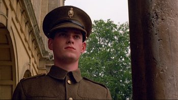 Movie still from “Another Country” (1984), directed by Marek Kanievska – A man in a military uniform stands in front of a building; Close Up shot, Low angle