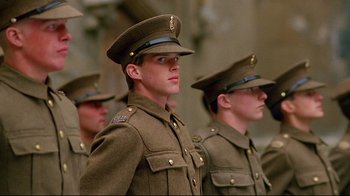 Movie still from “Another Country” (1984), directed by Marek Kanievska – A group of men in military uniforms standing next to each other; Close Up shot, Low angle