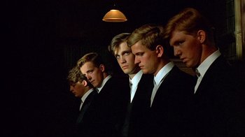 Movie still from “Another Country” (1984), directed by Marek Kanievska – A group of young men in suits standing in a row; Close Up shot, Low angle
