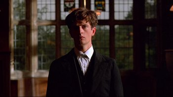 Movie still from “Another Country” (1984), directed by Marek Kanievska – A man in a suit and tie standing in front of a window; Close Up shot, Low angle