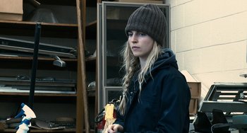 Movie still from “Another Earth” (2011), directed by Mike Cahill – A woman in a hat holding a piece of paper; Close Up shot, Over the shoulder angle