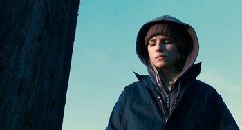 Movie still from “Another Earth” (2011), directed by Mike Cahill – A person wearing a hooded jacket and a hat; Close Up shot, Low angle