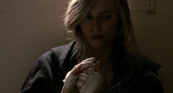 Movie still from “Another Earth” (2011), directed by Mike Cahill – A woman wearing a white glove holding something in her hand; Close Up shot, High angle