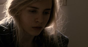 Movie still from “Another Earth” (2011), directed by Mike Cahill – A person with long blonde hair; Close Up shot, Low angle
