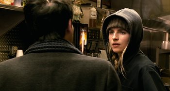 Movie still from “Another Earth” (2011), directed by Mike Cahill – A woman in a hooded jacket looking at a man in a black jacket; Close Up shot, Over the shoulder angle