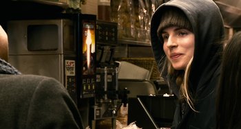 Movie still from “Another Earth” (2011), directed by Mike Cahill – A woman sitting in front of an oven in front of a microwave; Close Up shot, Over the shoulder angle