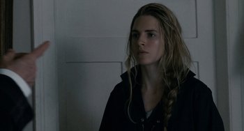 Movie still from “Another Earth” (2011), directed by Mike Cahill – A woman with long blonde hair is looking at the camera; Close Up shot, Over the shoulder angle