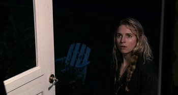 Movie still from “Another Earth” (2011), directed by Mike Cahill – A woman standing in front of an open white door; Close Up shot, Over the shoulder angle