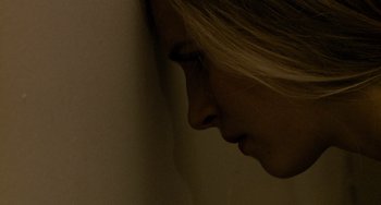 Movie still from “Another Earth” (2011), directed by Mike Cahill – A woman's face with her hand on her face; Extreme Close Up shot, Low angle