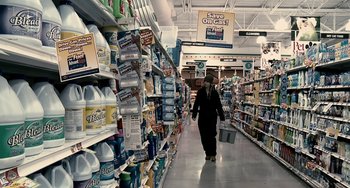 Movie still from “Another Earth” (2011), directed by Mike Cahill – A woman walking down the aisle of a grocery store; Wide shot, High angle