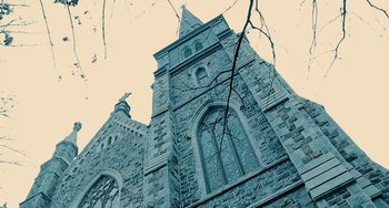 Movie still from “Another Earth” (2011), directed by Mike Cahill – A very tall building with a very large window; Extreme Wide shot, Low angle