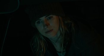 Movie still from “Another Earth” (2011), directed by Mike Cahill – A woman wearing a hat is looking at the camera; Close Up shot, Low angle