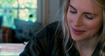 Movie still from “Another Earth” (2011), directed by Mike Cahill – A woman's face as she sits at a table; Close Up shot, Over the shoulder angle