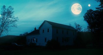 Movie still from “Another Earth” (2011), directed by Mike Cahill – A large white house with a large moon in the background; Extreme Wide shot, Low angle