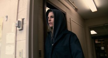 Movie still from “Another Earth” (2011), directed by Mike Cahill – A woman wearing a hooded jacket standing next to a door; Close Up shot, Low angle