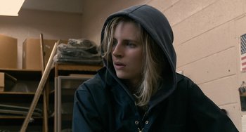 Movie still from “Another Earth” (2011), directed by Mike Cahill – A person wearing a black jacket with a hood up; Close Up shot, Over the shoulder angle