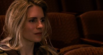 Movie still from “Another Earth” (2011), directed by Mike Cahill – A beautiful young lady sitting on a couch; Close Up shot, Over the shoulder angle