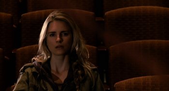 Movie still from “Another Earth” (2011), directed by Mike Cahill – A woman sitting in a movie theater with her eyes closed; Close Up shot, High angle