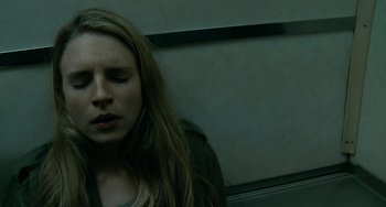 Movie still from “Another Earth” (2011), directed by Mike Cahill – A woman sitting on a train with her eyes closed; Close Up shot, Overhead angle