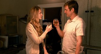 Movie still from “Another Earth” (2011), directed by Mike Cahill – A man and a woman are holding a drink; Medium shot, Over the shoulder angle