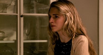 Movie still from “Another Earth” (2011), directed by Mike Cahill – A woman sitting in front of an open cabinet; Close Up shot, Over the shoulder angle